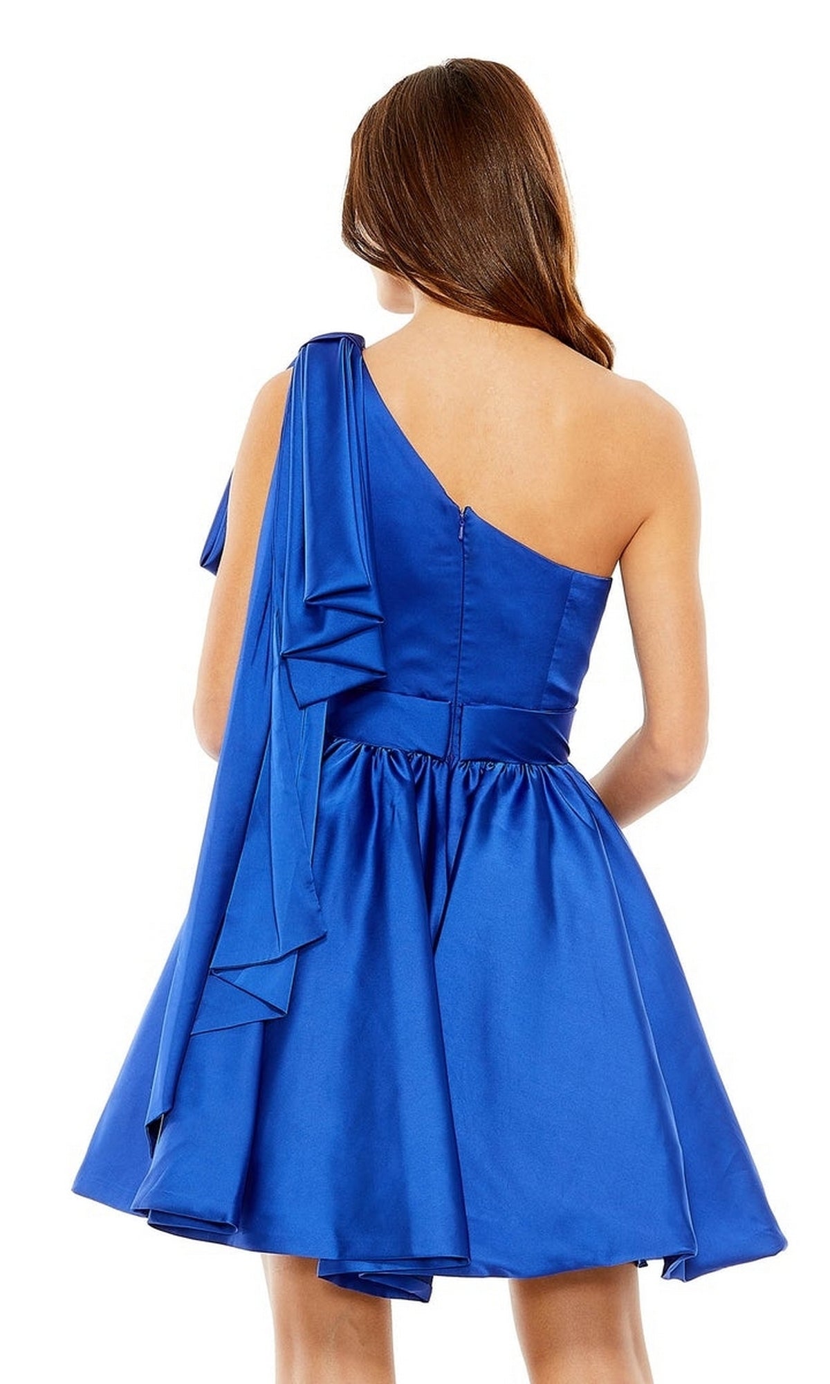 A woman is shown from the back wearing the Mac Duggal 20690 short cobalt blue hoco dress, featuring a one-shoulder design with a draped sleeve detail.